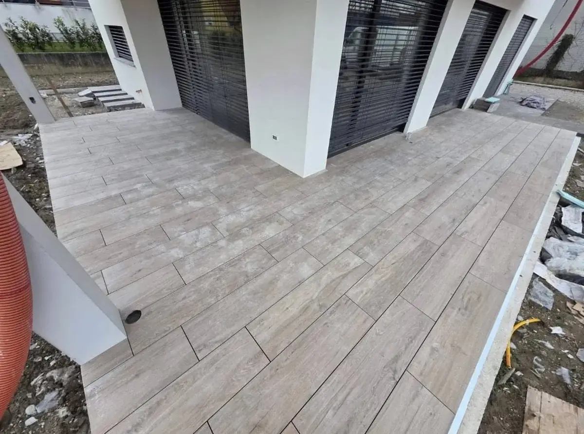Wood-effect porcelain pavers on Vitaro pedestals around a private residence entrance in Slovenia