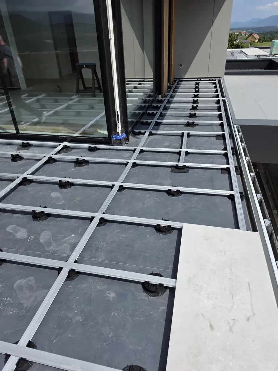 Pedestal grid running into the full-height window frame of a Slovenia mansion rooftop