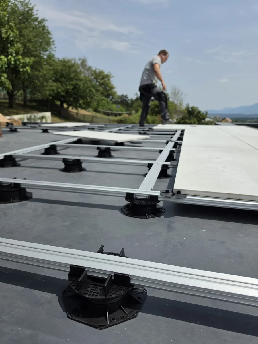 On-site install of aluminium joist grid over Vitaro pedestals on a Slovenia mansion rooftop